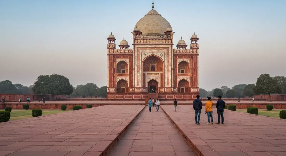 Akbar's Tomb at Sikandra, Agra, seen from the long approach through the charbagh garden, red sandstone and white marble glowing in early morning light