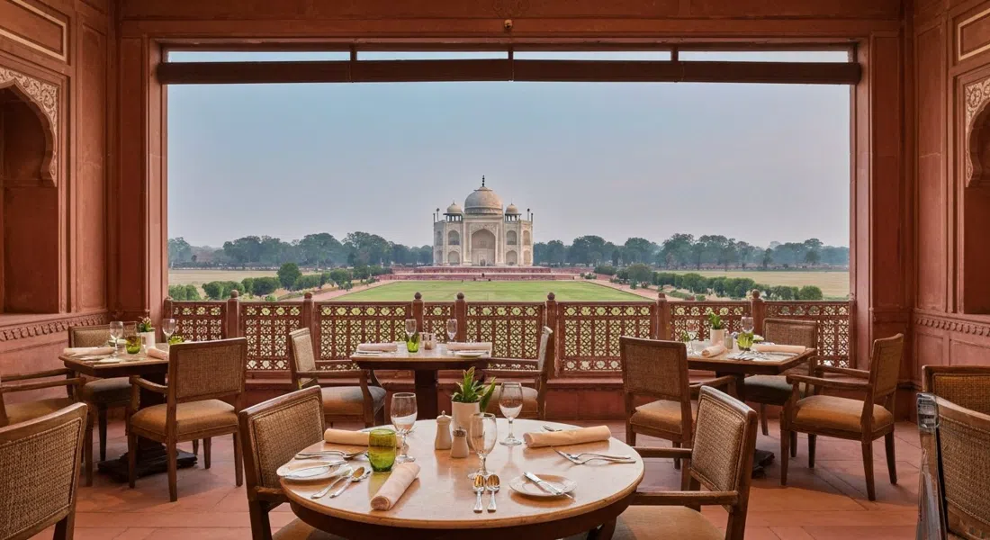 the fine-dining room at Esphahan inside The Oberoi Amarvilas, candlelit tables, formal place settings and a Taj-facing ambience at evening hour