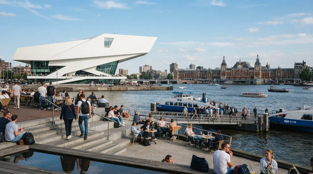 the white, angular EYE Filmmuseum on the IJ, seen from the ferry side with the stepped waterfront café and Centraal across the water