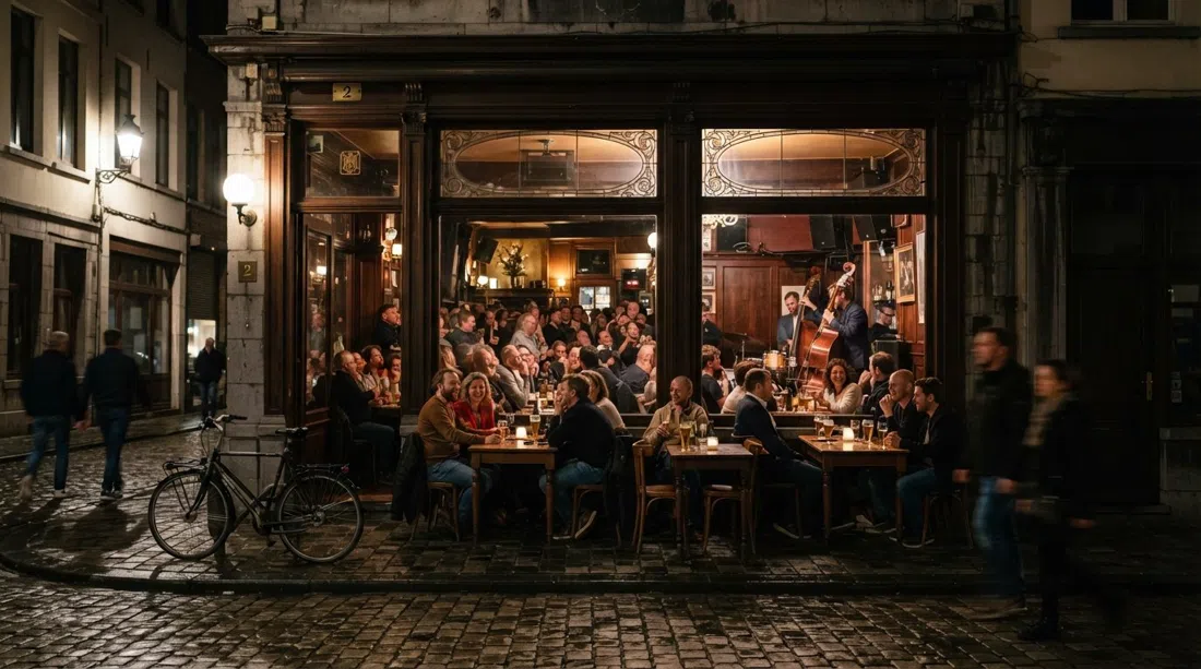 Café Hopper on Leopold de Waelstraat 2 at night, warm windows, beer glasses on tables and a small jazz crowd inside