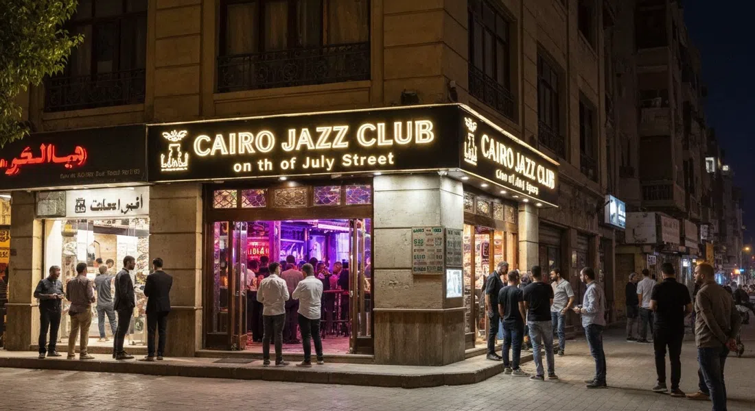 the exterior of Cairo Jazz Club on 26th of July Street at night, glowing sign, people queueing outside before live music