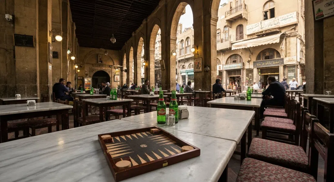 El Horreya near Falaki Square, a brightly lit cavernous cafe-bar with long marble tables, Stella bottles and a backgammon board under warm indoor light