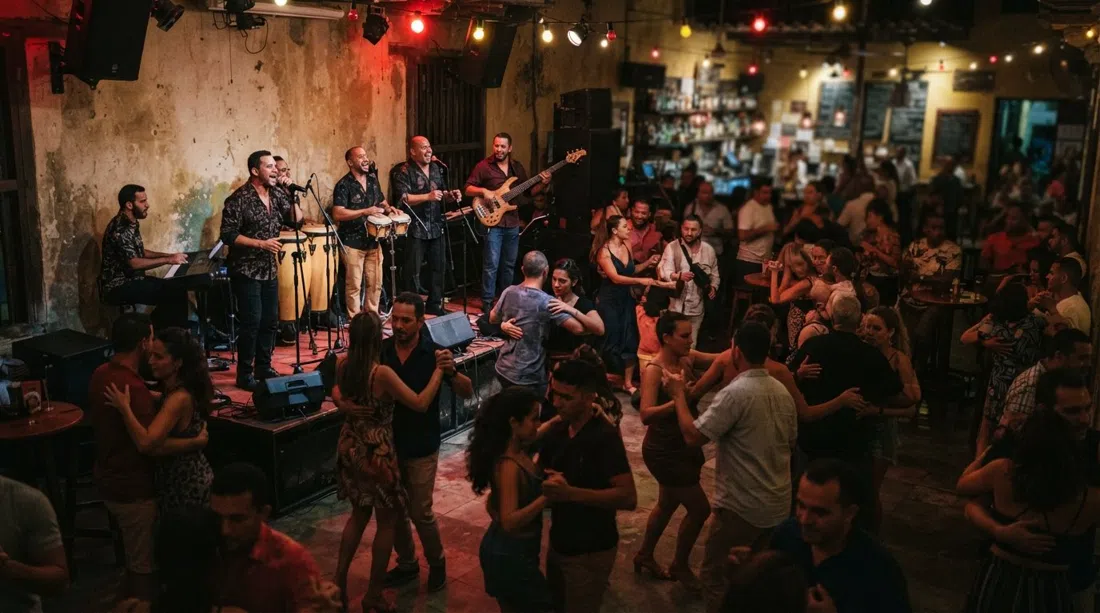 Cafe Havana in Getsemaní at night, live salsa band on a small stage, crowded dance floor and dim Cuban-style lighting