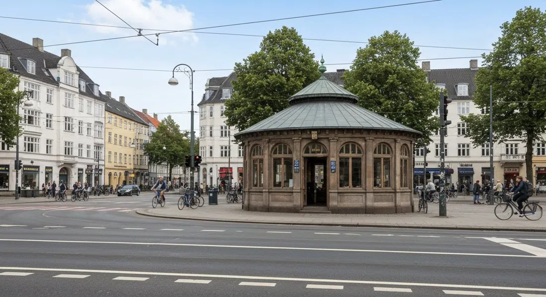 Trianglen in Østerbro at street level, the 1907 former tram waiting-room nicknamed “the turtle” framed by wide roads, cyclists and five-storey stucco blocks