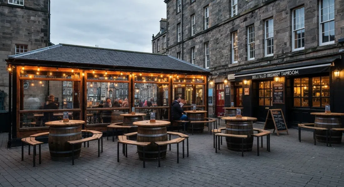 Bellfield Brewery Taproom on Stanley Place, the heated beer garden with barrel tables and beer-hall benches under soft evening light