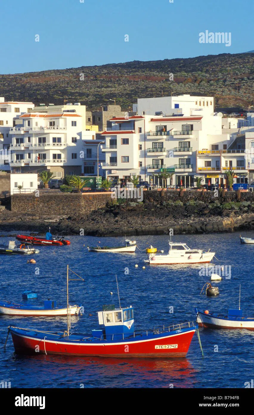 The harbour front of La Restinga, low white houses and fishing boats at the southern tip of El Hierro