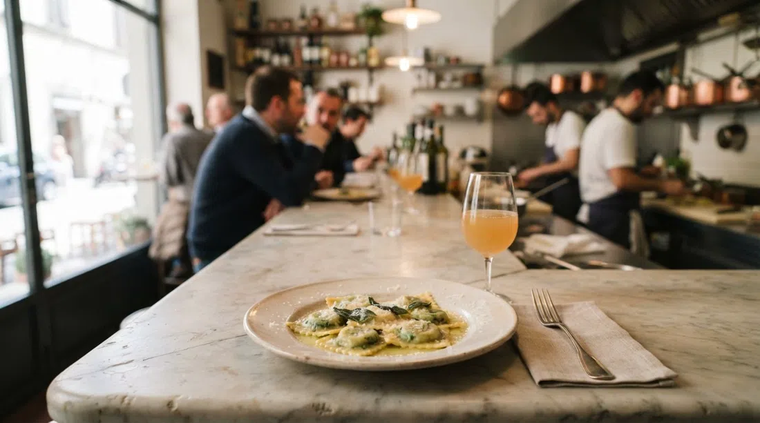 house-made ravioli in sage butter at Zeb, plated simply beside a glass of natural wine on the marble counter