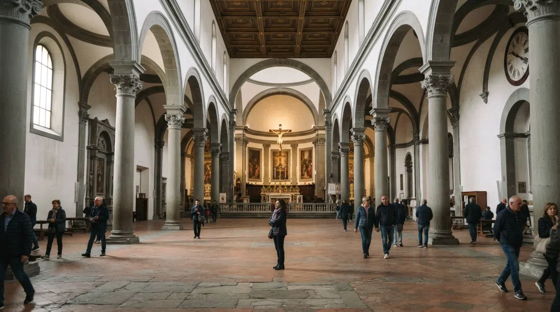 The interior of Basilica di Santo Spirito with grey pietra serena columns and soft side light falling across the nave