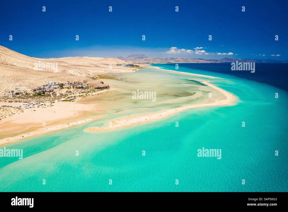 the two-kilometre arc of pale-gold sand at Costa Calma beach, lined with sun loungers and parasols
