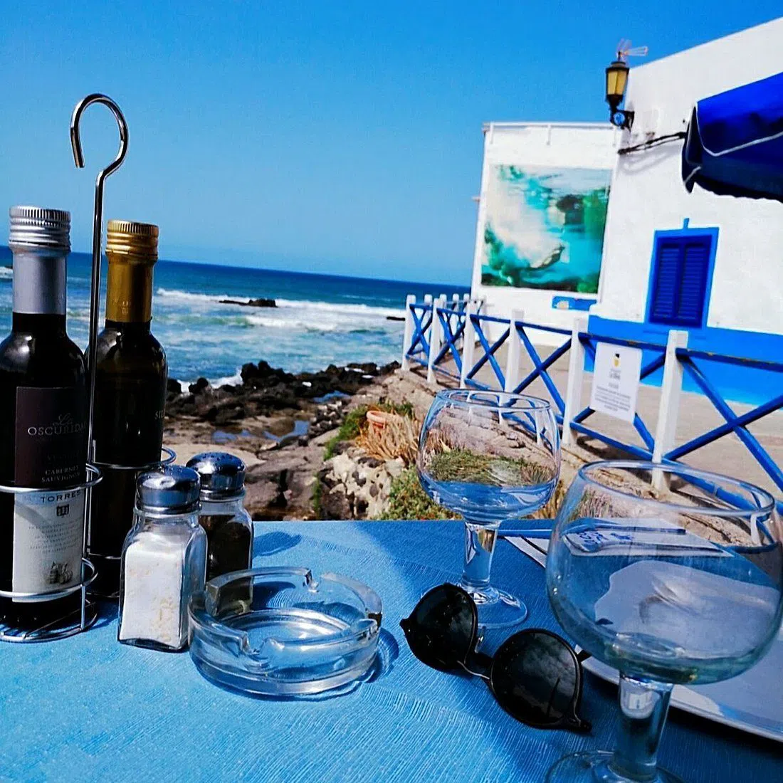 the waterside terrace at La Vaca Azul in El Cotillo, tables set above the rocks