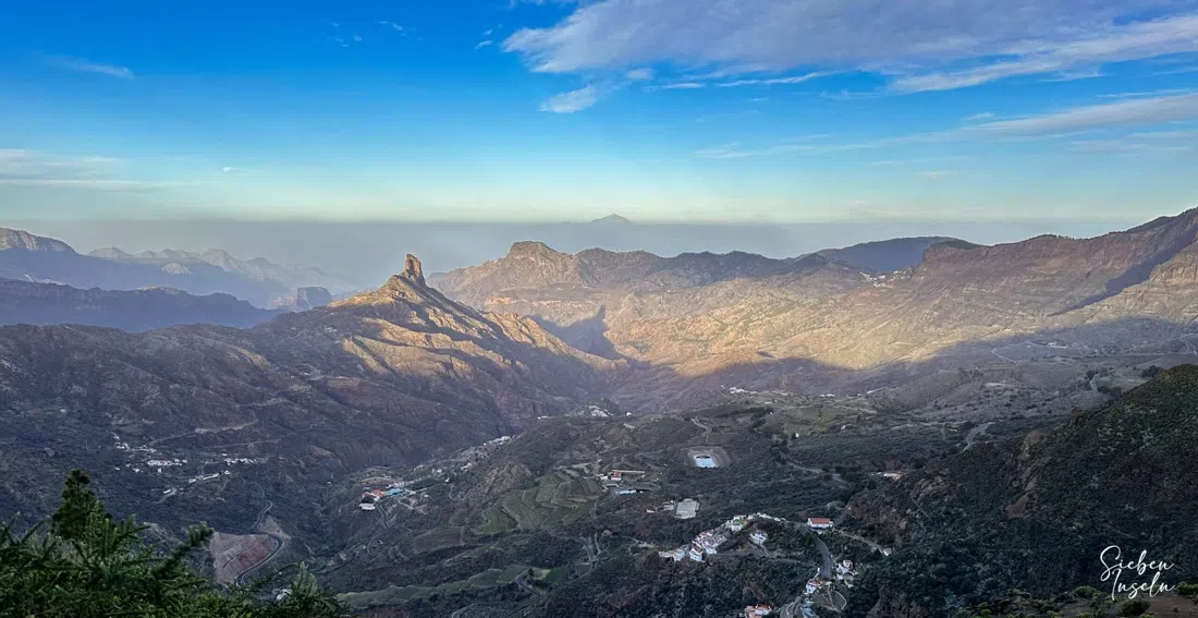 the stone cross and the village panorama seen from the Plaza del Ayuntamiento viewpoint in Tejeda