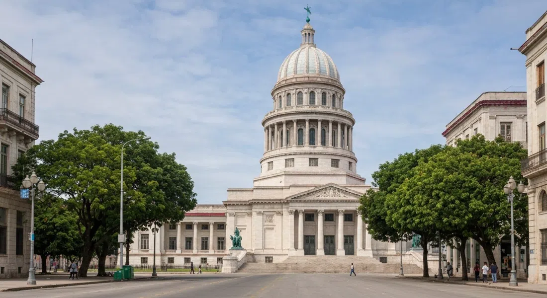 El Capitolio’s restored dome and steps at the eastern edge of Centro Habana, seen from street level with the Paseo del Prado trees nearby