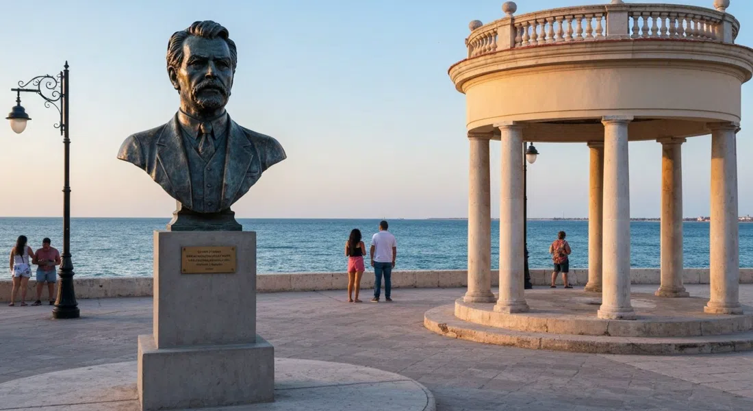 the bronze Hemingway bust under a small neoclassical rotunda by the water in Cojímar, late-afternoon light on the sea beyond