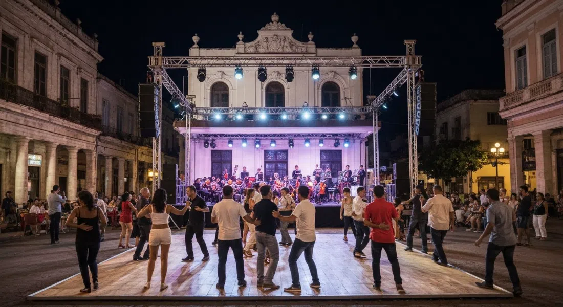 Casa de la Música Miramar at night, dancers on a packed salsa floor under stage lights with the live orchestra behind them