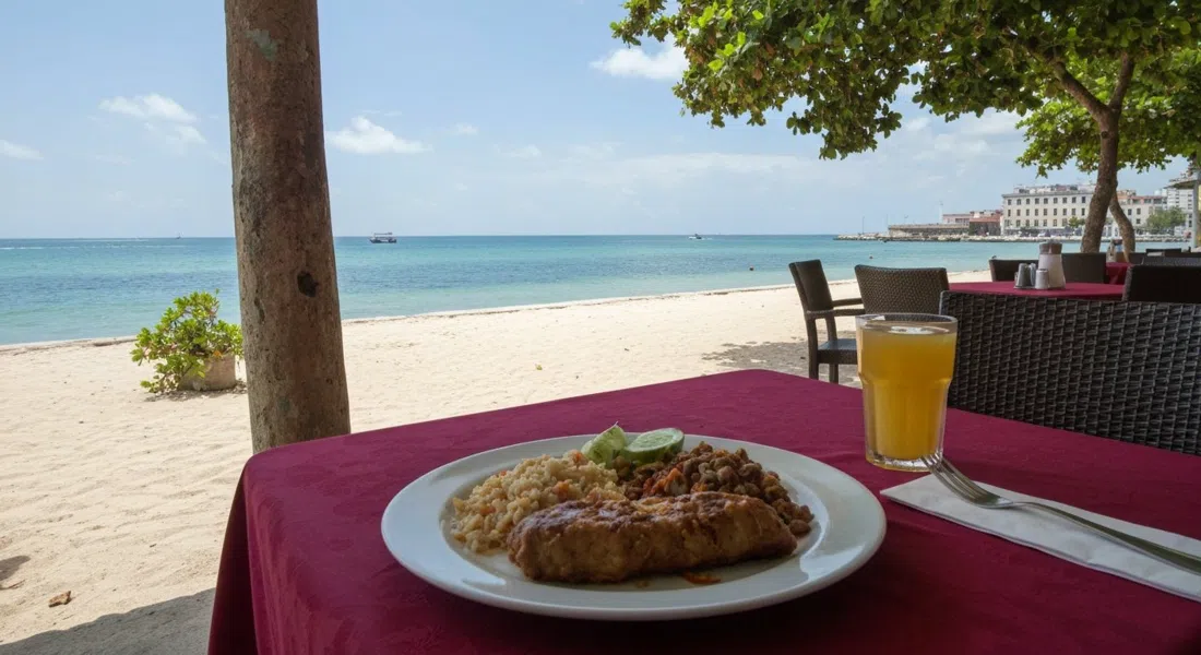 a beachfront table at El Chelo in Club Habana, with a plate of ropa vieja and the Straits of Florida visible beyond the sand