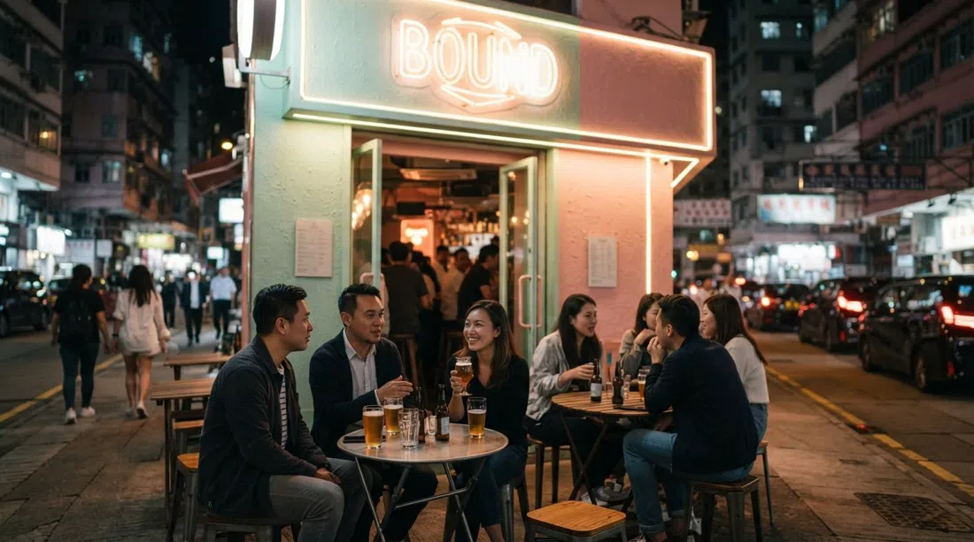 BOUND on Boundary Street at night, pastel facade and neon lighting with small tables, local craft beer glasses and a calm neighbourhood crowd