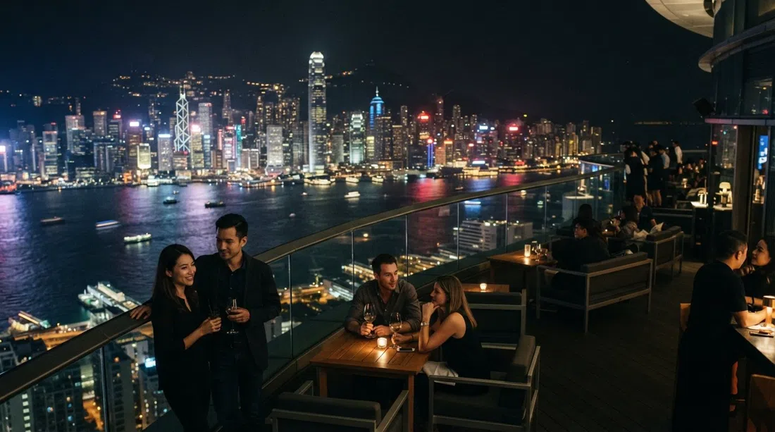 the harbour-view terrace at Ozone high above the ICC, night skyline far below and Victoria Harbour stretched into the distance