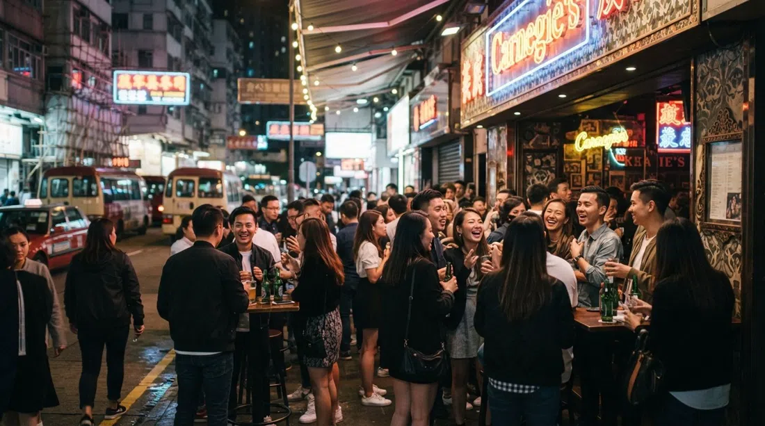 Carnegie's on Lockhart Road in Wan Chai, neon-lit bar frontage with a crowd gathered outside at night
