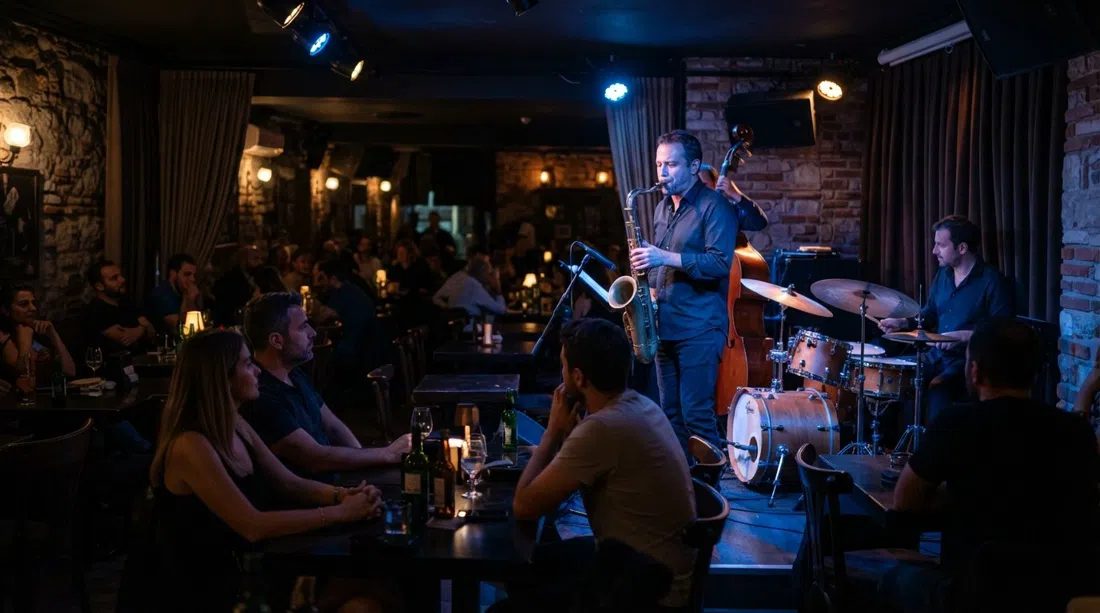 Nardis Jazz Club below Galata Tower, a dim intimate room with a small stage, close-set tables and blue light catching the brass of a saxophone