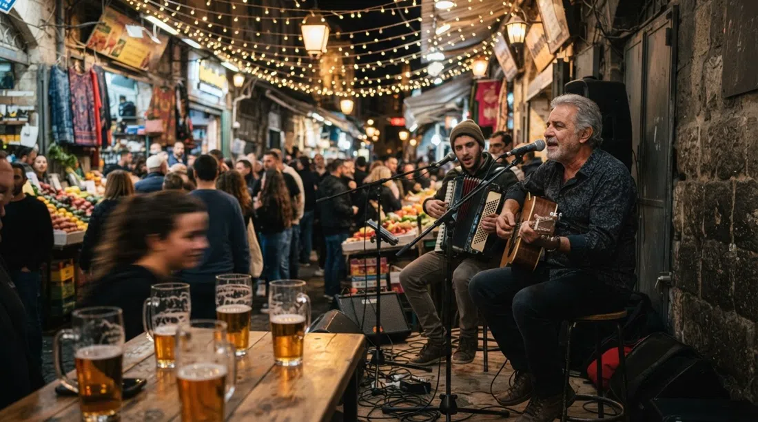 Freddy Lemon in the shuk at night, musicians playing under string lights while beer glasses catch the glow