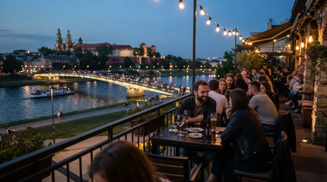 Drukarnia Jazz Club terrace on Nadwiślańska 1 facing the Vistula at dusk, with the river and bridge lights in view
