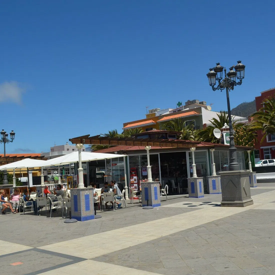 Plaza Francisca de Gazmira in El Paso, locals at café tables on a bright weekday morning