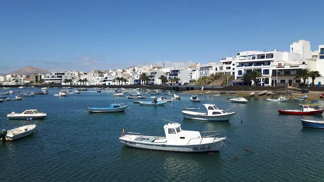 the Charco de San Ginés tidal lagoon in Arrecife, ringed by whitewashed fishermen's cottages