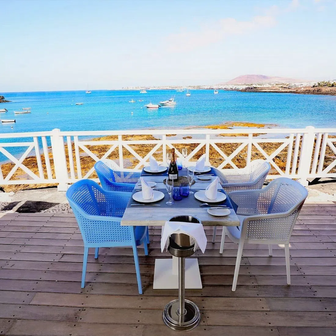 the terrace at Casa Carlos at Marina Rubicón, Playa Blanca, overlooking moored yachts at sunset