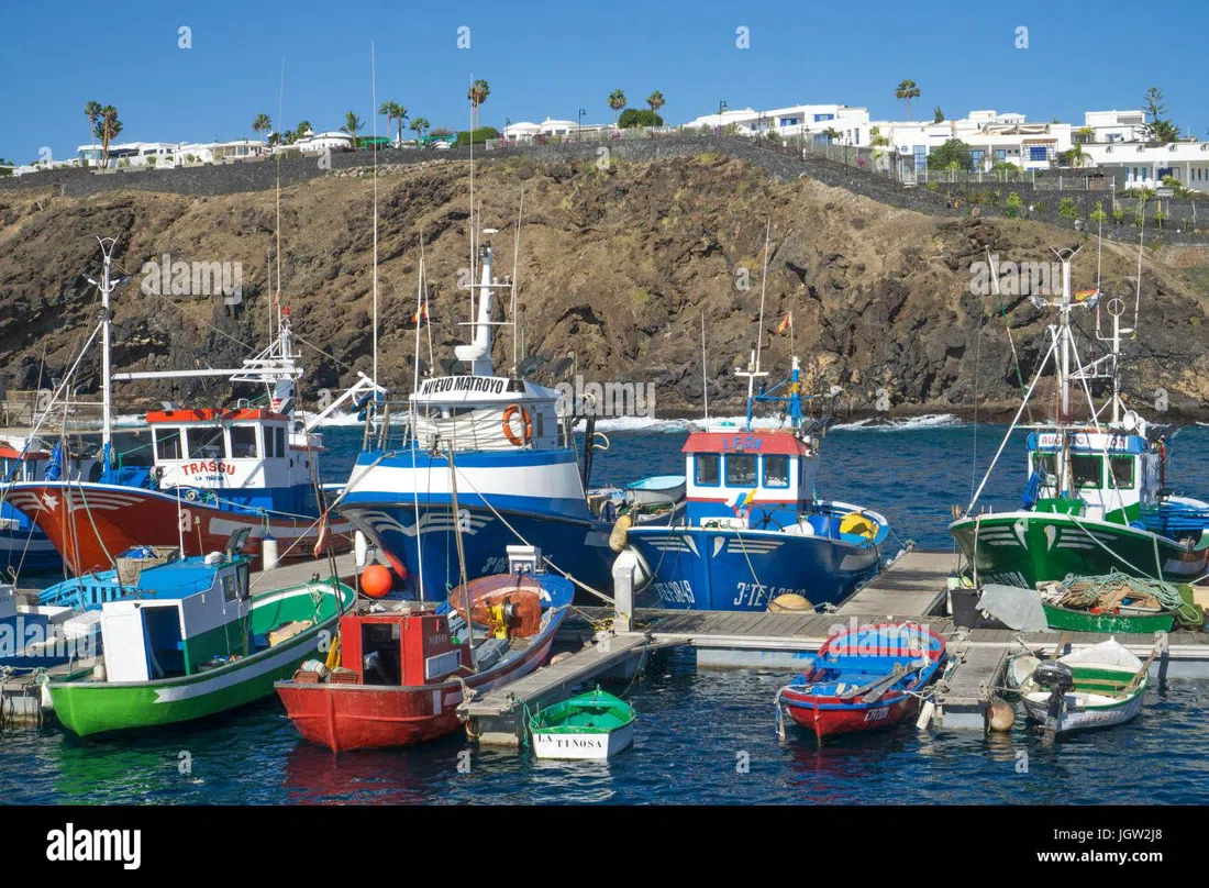 the old fishing harbour at Puerto Tiñosa in Puerto del Carmen, whitewashed buildings and boats hauled up on the slipway