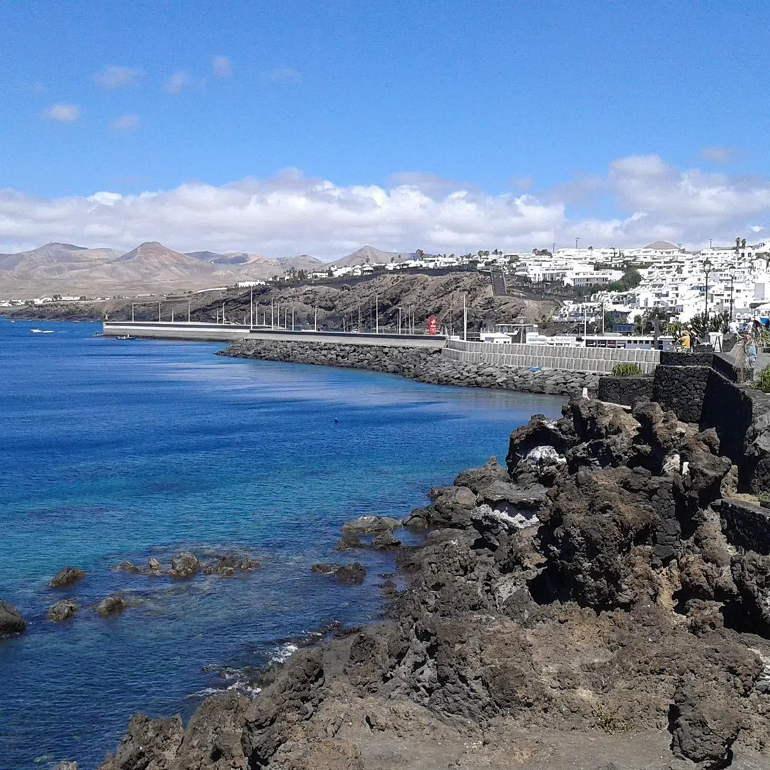 Playa Chica cove in Puerto del Carmen with snorkellers entering the water