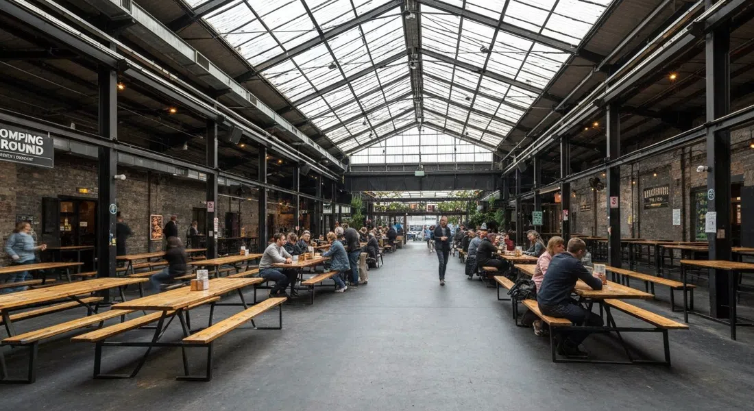 Stomping Ground’s cavernous warehouse beer hall on Gipps Street, paddles on tables and the retractable-roof garden area visible in industrial daylight