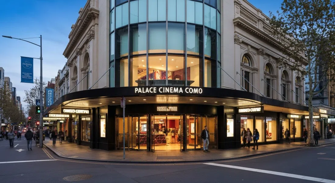 the glass-fronted entrance of Palace Cinema Como on the Toorak Road and Chapel Street corner at dusk, with the Como Centre glowing around it