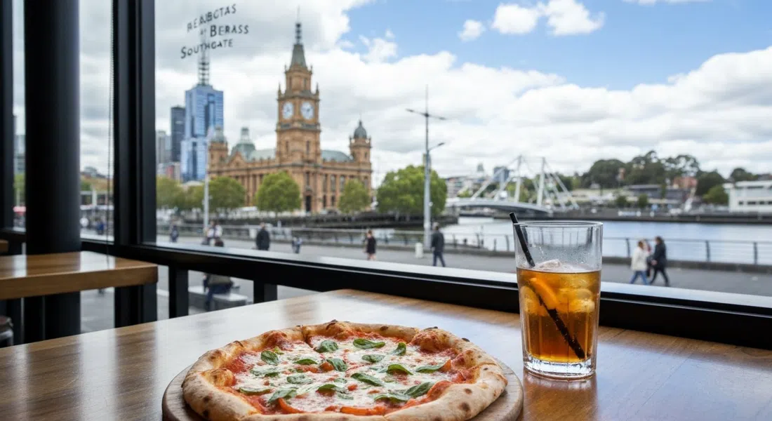 a wood-fired pizza and a drink at BearBrass at Southgate, with the Southbank Promenade and river visible through the windows