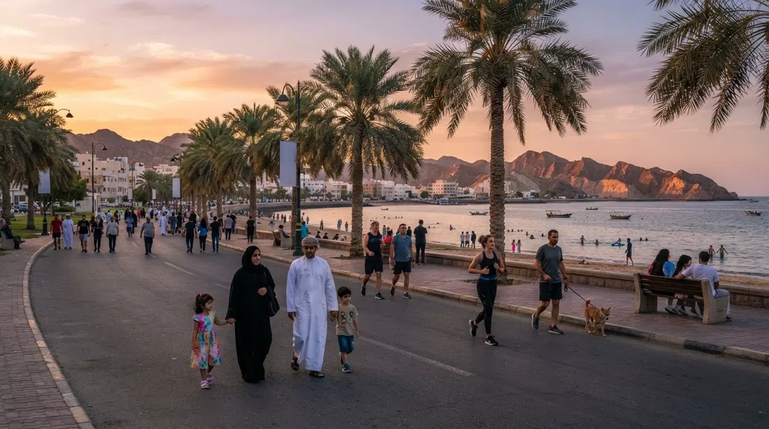 Qurum Beach and the Love Street promenade at sunset, palm trees lining the corniche with joggers and families on the path