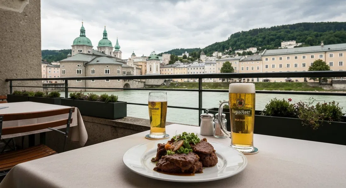 a terrace table at Bärenwirt on Müllner Hauptstraße 8, plated Backhendl and a glass of Augustiner beer with the Salzach and Kapuzinerberg beyond