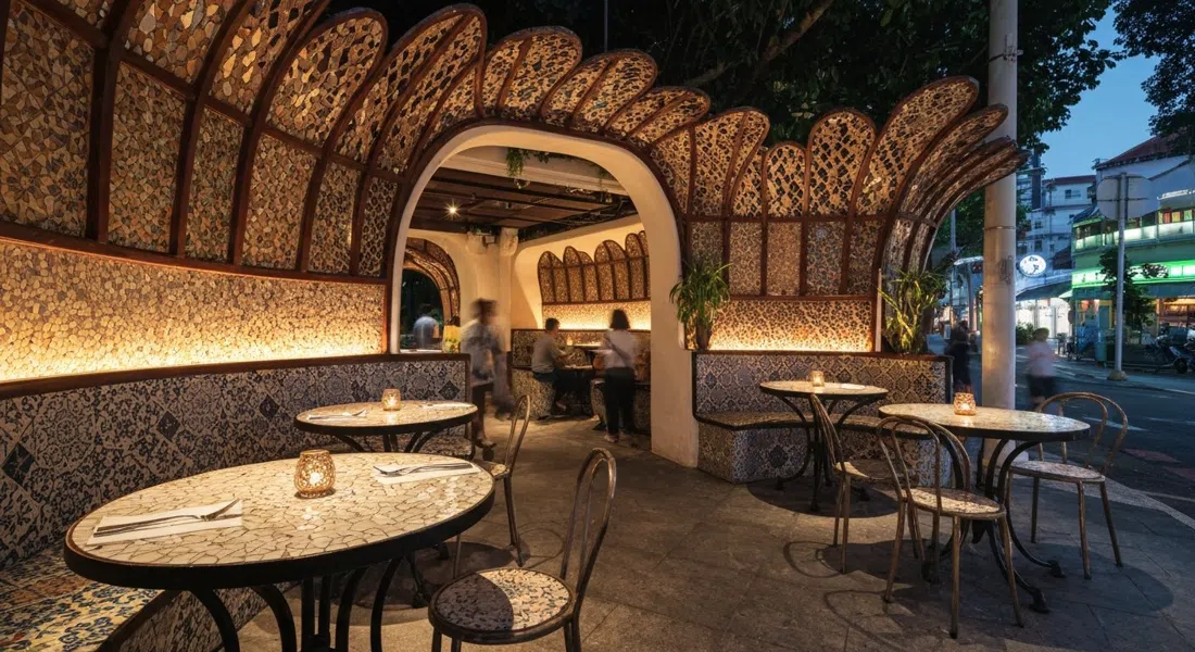 the intimate Gaudí Room speakeasy behind Carlitos on Joo Chiat Road, mosaic tables, curved walls and butterfly-lattice woodwork lit by warm evening light