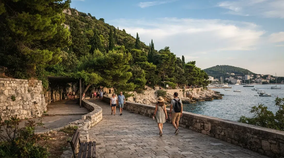 Šetalište Ivana Meštrovića under Marjan hill in late afternoon light, stone walls and pine shade lining the seafront road