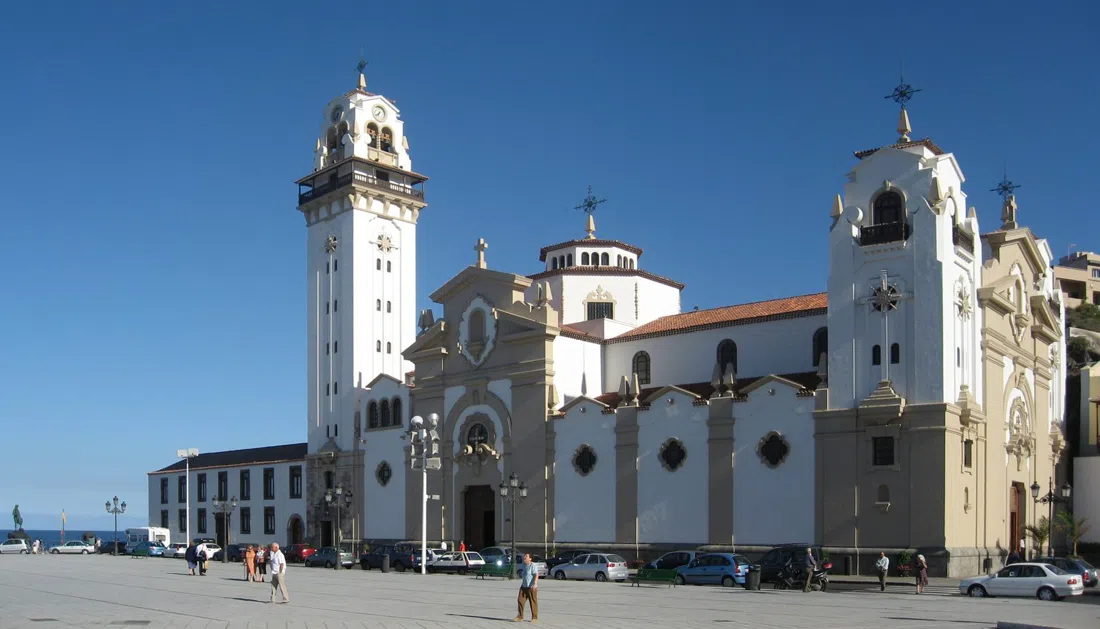 the plain white facade of the Basilica of Candelaria facing the ocean across Plaza de la Patrona de Canarias
