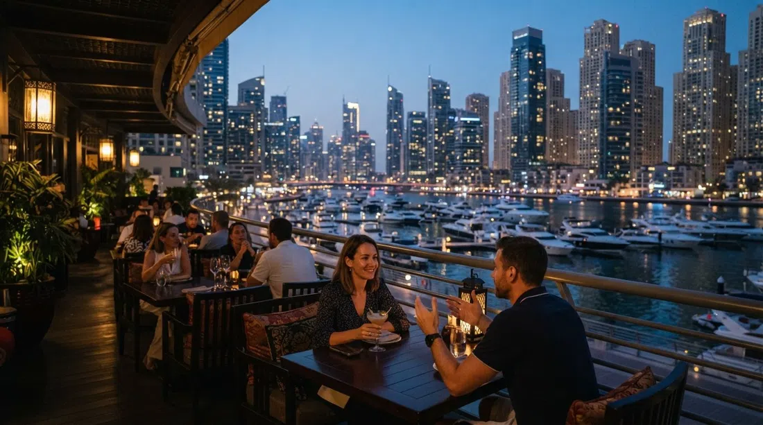 the wraparound terrace at Asia Asia in Pier 7, looking over the Marina yacht bay at dusk with city lights starting to flicker on