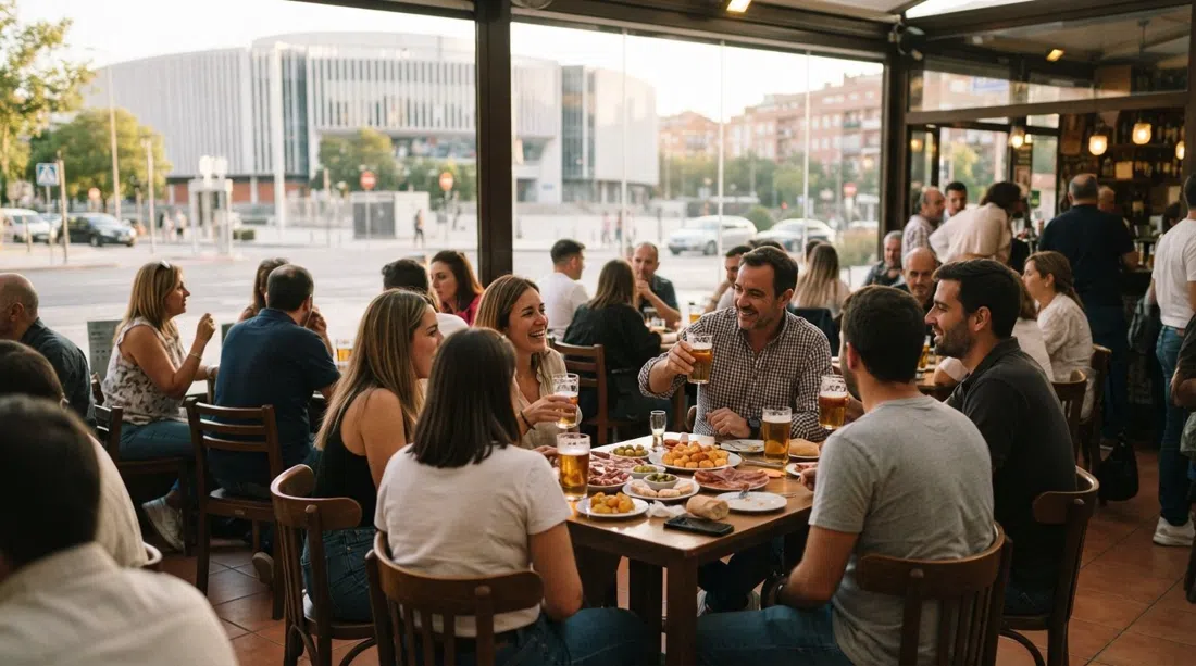 the glassed-in terrace at Cervecería Ecu opposite the Palacio de Deportes, filled with locals over beers and oversized free tapas in late-afternoon light
