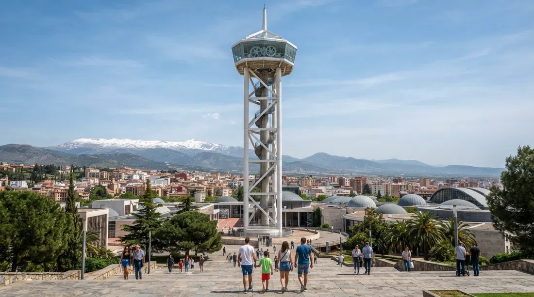 the 50-metre observation tower at Parque de las Ciencias, seen from below with the museum complex and the city stretching out toward the Sierra Nevada