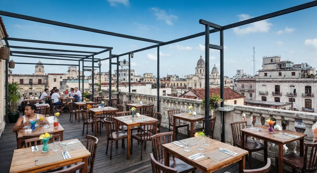 the rooftop terrace at El del Frente on O'Reilly 303, tables set under open sky with cocktails and Old Havana rooftops in the background