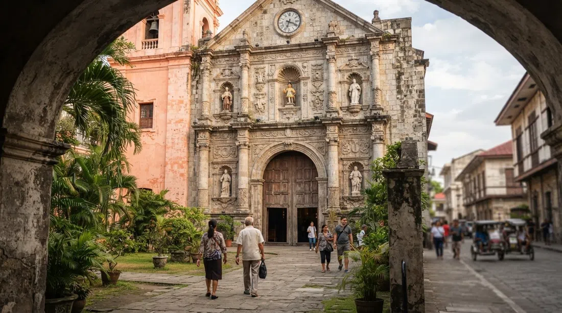 San Agustin Church facade on General Luna Street, weathered stone glowing softly in Manila daylight with the church entrance framed by the old courtyard