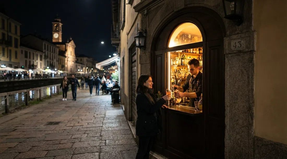 the tiny hatch-front of Backdoor 43 on Ripa di Porta Ticinese at night, with a narrow bar interior and glowing cocktail service window