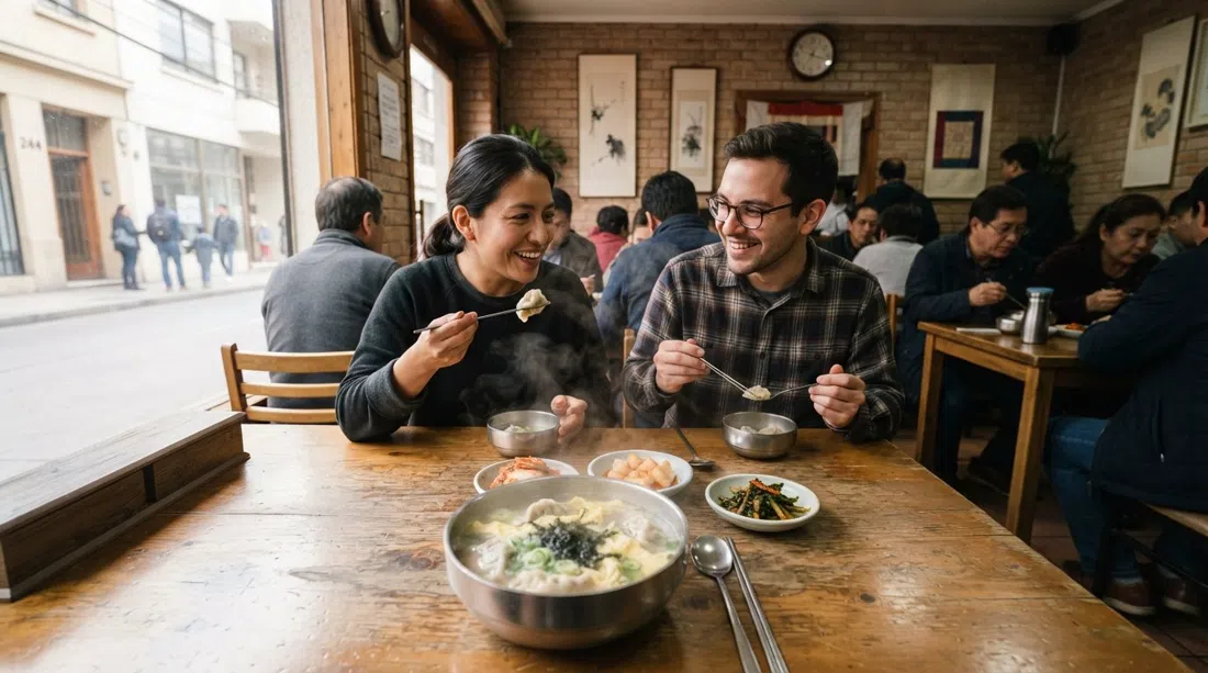 the interior of Sukine on Antonia López de Bello 244 with a steaming bowl of dumpling soup, kimchi plates and a modest Korean dining room at lunch