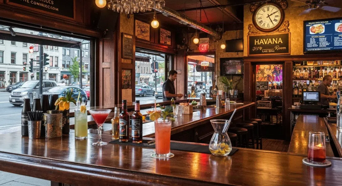 The Flamingo Room inside Havana at 1212 Commercial, tropical cocktails on the bar and a small live-music setup under warm evening light