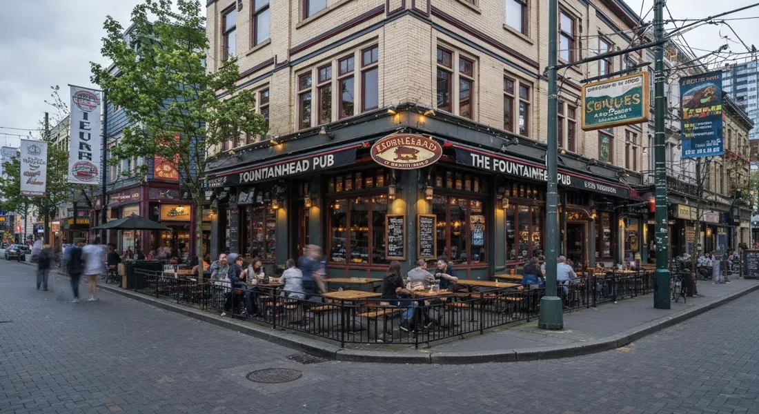 The Fountainhead Pub on Davie Street, big patio tables under evening light with the corner pub frontage and rainbow Village energy